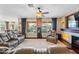 Well-lit living room with plush seating, a fireplace, and large windows offering great views at 683 W Honey Locust Ave, Queen Creek, AZ 85140