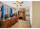 This office features a beautiful, large wood desk and a built-in bookcase at 683 W Honey Locust Ave, Queen Creek, AZ 85140