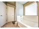 Bright bathroom with white tub and tiled floor at 935 S Deerfield Ln, Gilbert, AZ 85296