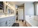 Bright bathroom featuring a double vanity with tub and toilet area in a separate room at 935 S Deerfield Ln, Gilbert, AZ 85296