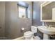 Stylish half bathroom features neutral walls, a pedestal sink, and modern fixtures at 935 S Deerfield Ln, Gilbert, AZ 85296