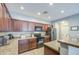 Well-lit kitchen features granite countertops, stainless steel refrigerator, and tiled backsplash at 935 S Deerfield Ln, Gilbert, AZ 85296