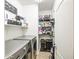 Efficient laundry room with modern machines, shelving, and ample storage space at 935 S Deerfield Ln, Gilbert, AZ 85296