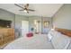 Comfortable main bedroom has a ceiling fan, natural light, and an en suite bathroom at 935 S Deerfield Ln, Gilbert, AZ 85296