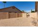 Low-maintenance backyard with privacy fence and gate at 9857 W Tonto Ln, Peoria, AZ 85382