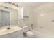 Bright bathroom featuring tile, a toilet, a shower and floral wallpaper at 9857 W Tonto Ln, Peoria, AZ 85382