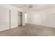 Bright bedroom featuring neutral carpet, closet, and a ceiling fan for added comfort at 9857 W Tonto Ln, Peoria, AZ 85382