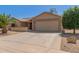 Charming single-story home featuring desert landscaping and an attached two-car garage at 9857 W Tonto Ln, Peoria, AZ 85382