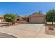 Charming single-story home featuring desert landscaping and an attached two-car garage at 9857 W Tonto Ln, Peoria, AZ 85382