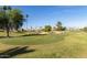 Scenic view of the meticulously maintained golf course with mature trees and lush green grass at 9857 W Tonto Ln, Peoria, AZ 85382