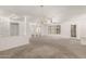 Bright living room with carpet, chandelier, and lots of natural light offering a welcoming space at 9857 W Tonto Ln, Peoria, AZ 85382