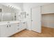 Bright bathroom featuring double vanity, modern fixtures, and a separate closet at 10341 E Dragoon Ave, Mesa, AZ 85208