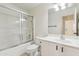 Clean bathroom features a shower-tub combo with glass doors and a single sink vanity at 10341 E Dragoon Ave, Mesa, AZ 85208