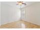 Bright bedroom features a ceiling fan and a window with plantation shutters at 10341 E Dragoon Ave, Mesa, AZ 85208