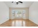 Bright bedroom with bay window, ceiling fan, and light wood floors at 10341 E Dragoon Ave, Mesa, AZ 85208