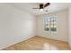 Bright bedroom features a ceiling fan and a window with plantation shutters at 10341 E Dragoon Ave, Mesa, AZ 85208