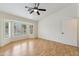 Spacious bedroom with natural light from bay window, ceiling fan, and wood-look floors at 10341 E Dragoon Ave, Mesa, AZ 85208