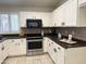Well-equipped kitchen with white cabinets, stainless steel appliances, and dark countertops at 10341 E Dragoon Ave, Mesa, AZ 85208