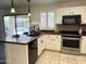 Modern kitchen with stainless steel appliances, black hardware, and a view of the backyard pool at 10341 E Dragoon Ave, Mesa, AZ 85208