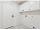 The laundry room features overhead storage, tile floors, and easy access to utilities at 10341 E Dragoon Ave, Mesa, AZ 85208