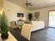 Inviting living room with stylish furniture, ceiling fan, and sliding glass doors to the pool at 10341 E Dragoon Ave, Mesa, AZ 85208
