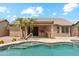 Backyard features a sparkling pool and a covered patio with an outdoor kitchen at 10341 E Dragoon Ave, Mesa, AZ 85208