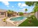 Backyard boasts a sparkling pool, mature landscaping, and a rock water feature at 10341 E Dragoon Ave, Mesa, AZ 85208