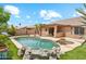 Backyard boasts a sparkling pool, mature landscaping, and a rock water feature at 10341 E Dragoon Ave, Mesa, AZ 85208