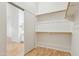 Bright walk-in closet features built-in shelving and sliding door access to the en suite bathroom at 10341 E Dragoon Ave, Mesa, AZ 85208