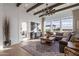 Spacious living room with wood beams, large windows, designer rug, and comfortable seating area at 1111 E Peach Tree Dr, Chandler, AZ 85249
