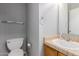 A bathroom with a toilet, sink, towel rack, and a framed mirror at 125 S 56Th St # 124, Mesa, AZ 85206