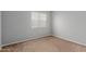 Another bedroom angle, showcasing neutral carpet and a large window at 125 S 56Th St # 124, Mesa, AZ 85206