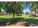 Green space nestled among the townhomes with well-maintained lawns and trees at 125 S 56Th St # 124, Mesa, AZ 85206
