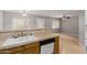 Well-lit kitchen with a dual basin sink, tile countertops, and modern appliances at 125 S 56Th St # 124, Mesa, AZ 85206