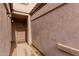 Close-up of covered walkway to front door with beige textured walls at 125 S 56Th St # 124, Mesa, AZ 85206