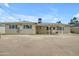 View of the home's backyard with covered patio and updated windows at 1719 E Dana Ave, Mesa, AZ 85204