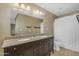 Bathroom featuring dual sinks, granite countertops, and ample storage space at 1719 E Dana Ave, Mesa, AZ 85204