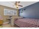 Bedroom featuring carpet, ceiling fan, window, and painted accent wall at 1719 E Dana Ave, Mesa, AZ 85204