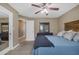 Bedroom includes ceiling fan, carpet, and easy access to the ensuite bathroom at 1719 E Dana Ave, Mesa, AZ 85204