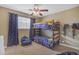 Comfortable bedroom with bunk beds, a ceiling fan, and ample natural light at 1719 E Dana Ave, Mesa, AZ 85204