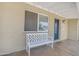 Inviting front porch featuring a stylish bench and view of the home's entrance and covered porch area at 1719 E Dana Ave, Mesa, AZ 85204