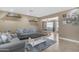 Bright living room featuring stylish sofas, decorative shelves, and an open view into the dining area at 1719 E Dana Ave, Mesa, AZ 85204