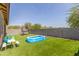 Lush backyard features an inflatable pool, trampoline, turf, and a play set at 17296 W Molly Ln, Surprise, AZ 85387