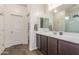 Bathroom with a large vanity, mirror, and view of the shower and the water closet at 17296 W Molly Ln, Surprise, AZ 85387