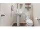 Charming bathroom features a pedestal sink, toilet, and modern fixtures at 17296 W Molly Ln, Surprise, AZ 85387
