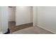 Neutral bedroom with carpet and tile flooring with a view into the hallway at 17296 W Molly Ln, Surprise, AZ 85387