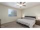 Comfortable bedroom featuring a ceiling fan, window with blinds, and neutral decor at 17296 W Molly Ln, Surprise, AZ 85387