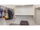 Walk-in closet with clothing racks, shelving, and a stool for easy access at 17296 W Molly Ln, Surprise, AZ 85387