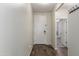 Inviting entryway featuring a pristine white front door, neutral walls, and stylish wood-look flooring at 17296 W Molly Ln, Surprise, AZ 85387