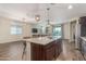 Open-concept kitchen and living room with an island and stainless appliances at 17296 W Molly Ln, Surprise, AZ 85387